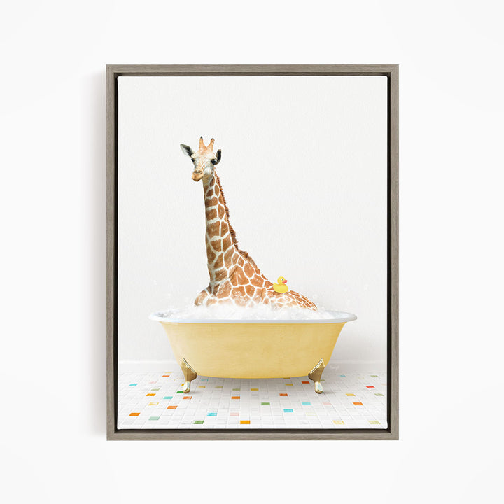A giraffe is sitting in a yellow bathtub filled with bubbles, with a rubber duck floating on the water.