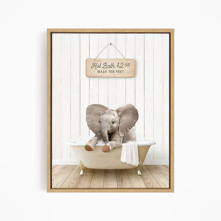 A wooden bathtub with a baby elephant sitting in it, and a sign above the bathtub that reads "Hot Bath $2.00 WASH YOUR FEET".