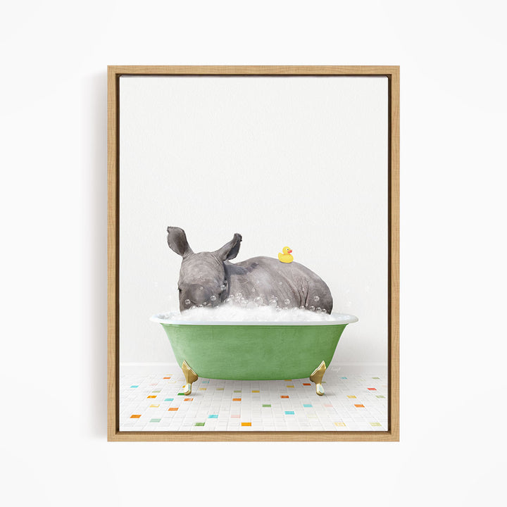 A rhinoceros is sitting in a green bathtub filled with bubbles, with a yellow rubber duck floating on its back.