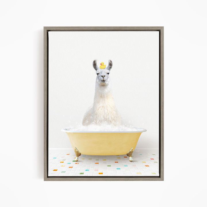 A white llama sitting in a yellow bathtub filled with bubbles, with a rubber duck floating on its head.