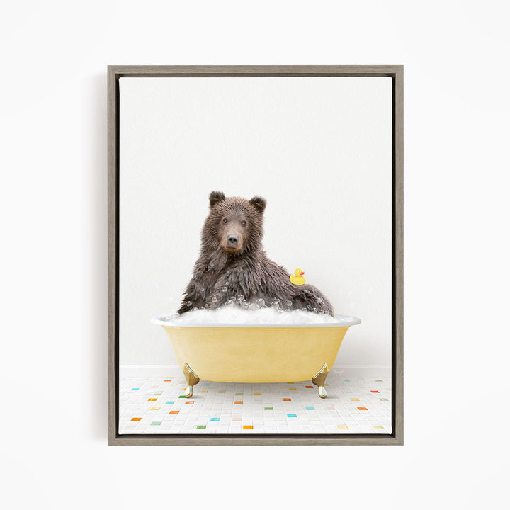 A brown bear sitting in a yellow bathtub, with a rubber duck floating on the water.