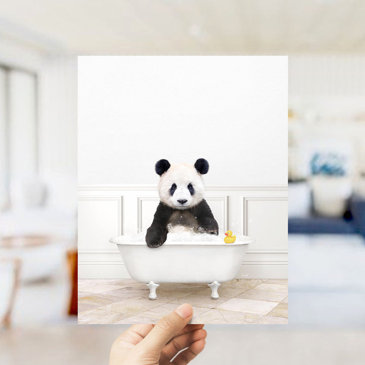 A panda bear sitting in a bathtub filled with bubbles, with a yellow rubber duck floating nearby.