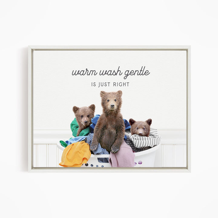 three bears sitting in a laundry basket filled with clothes, with a text overlay that reads "Warm wash gentle is just right".