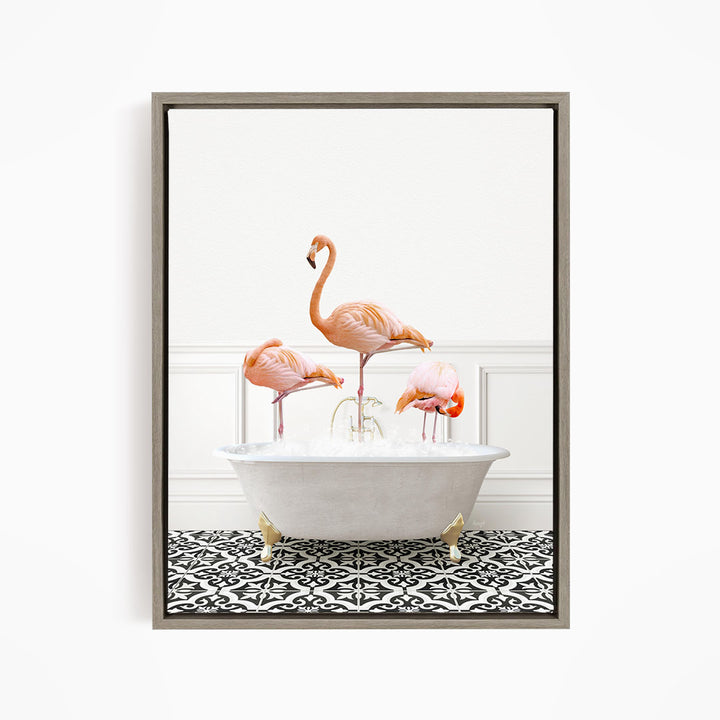 A framed image of three flamingos standing in a white bathtub filled with water, creating a whimsical and playful scene.