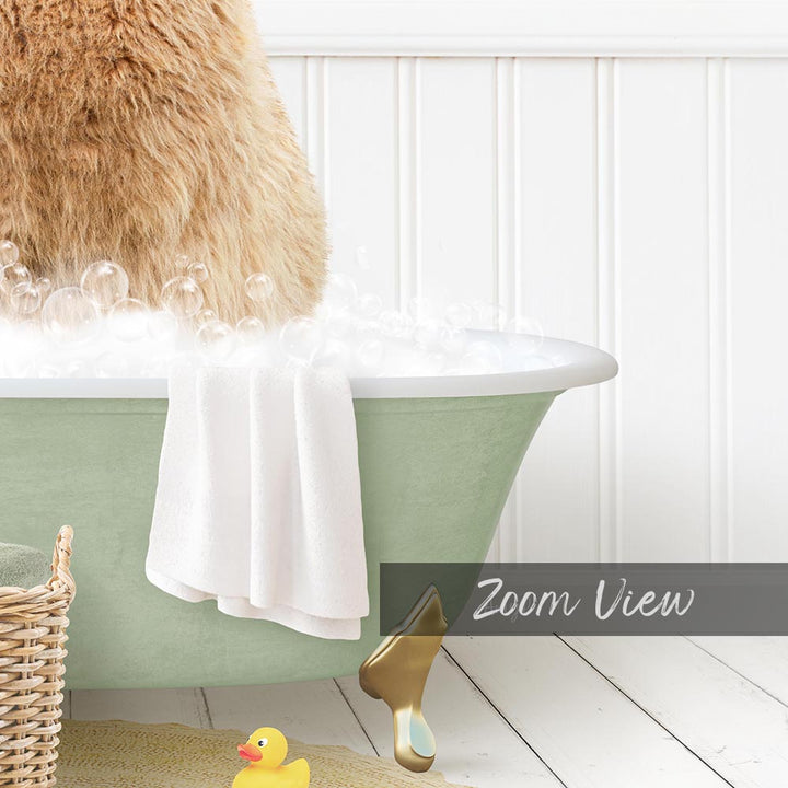 A fluffy brown dog is sitting in a green bathtub filled with bubbles, with a yellow rubber duck nearby.