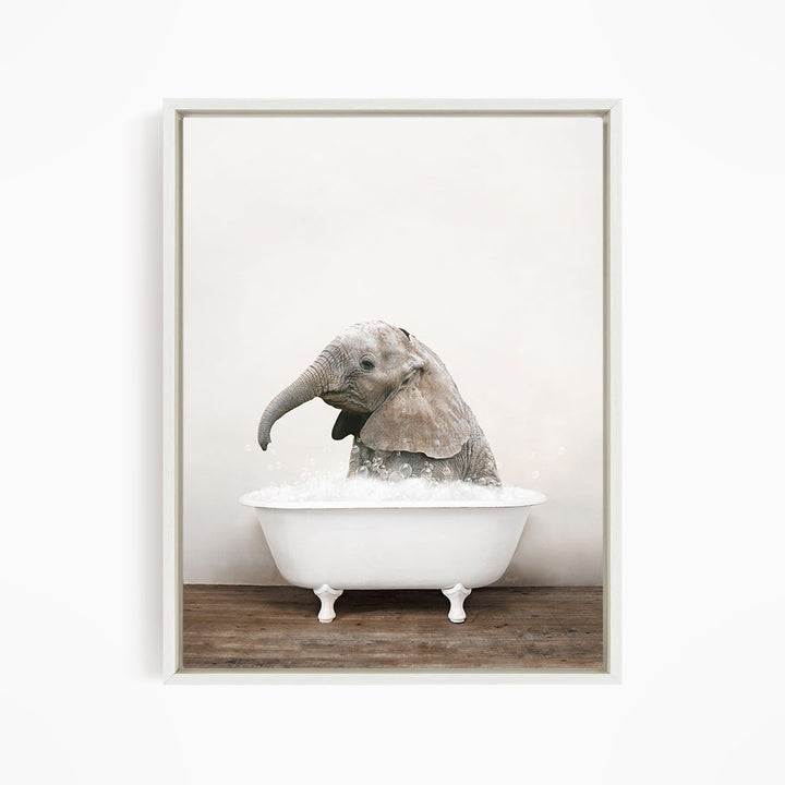 A baby elephant sitting in a white bathtub filled with water, creating a playful and whimsical scene.