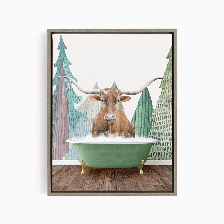 A brown cow with large horns is sitting in a green bathtub, surrounded by trees with green and brown foliage.