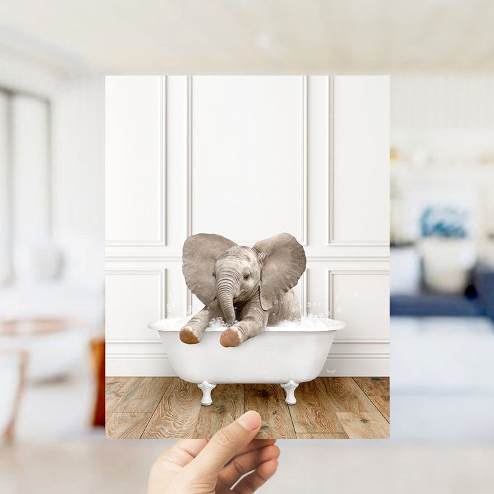 A small elephant sitting in a white bathtub, with its trunk submerged in water, creating a whimsical and playful scene.
