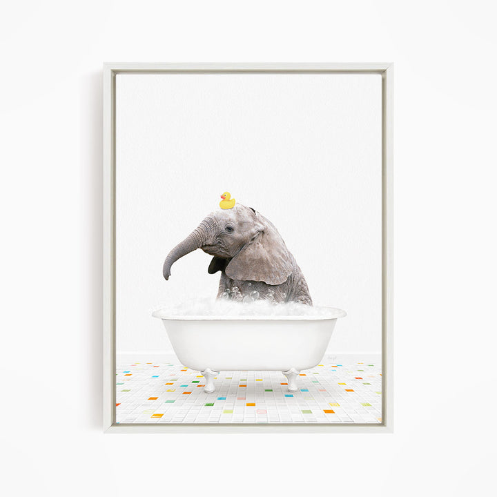 A baby elephant sitting in a white bathtub, with a yellow rubber duck perched on its head.
