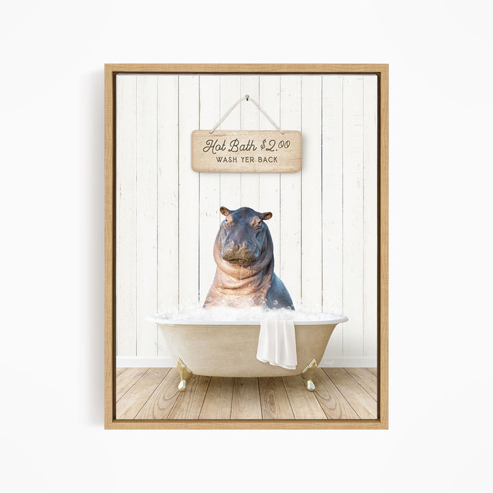 A framed image of a hippopotamus sitting in a bathtub, with a wooden sign above it that reads "Hot Bath $2.00 WASH YER BACK".