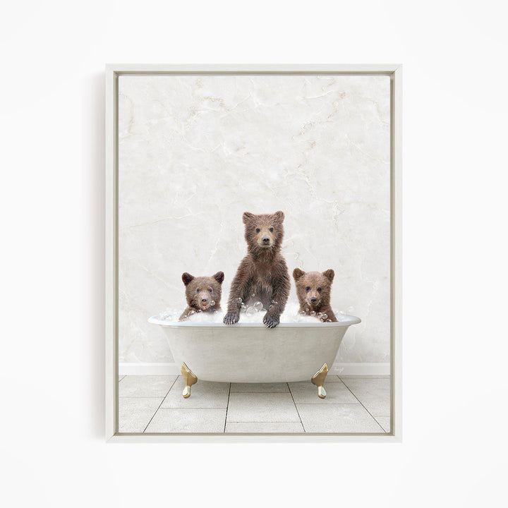 A framed image depicting three brown bears sitting in a white bathtub, with one bear sitting in the center and the other two bears sitting on either side.