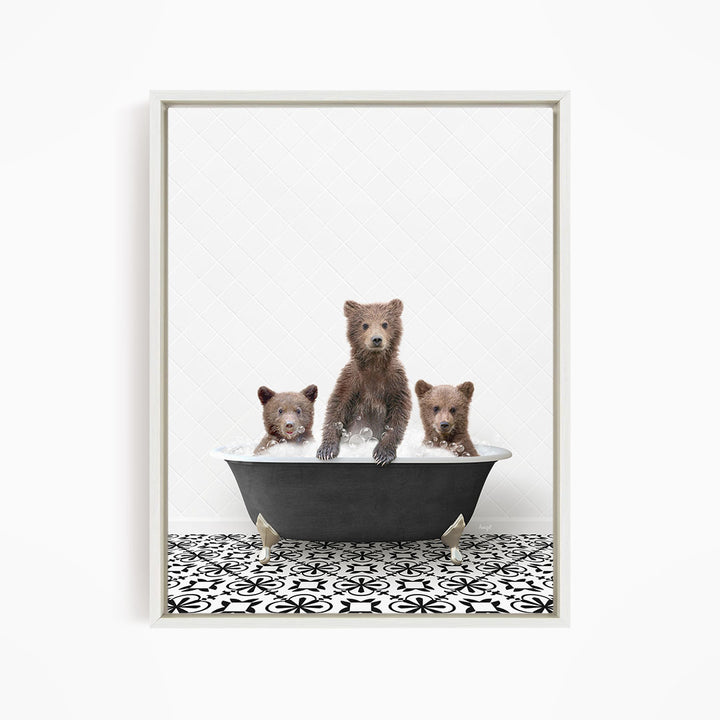 Three adorable brown bears sitting in a black bathtub filled with water, creating a playful and whimsical scene.