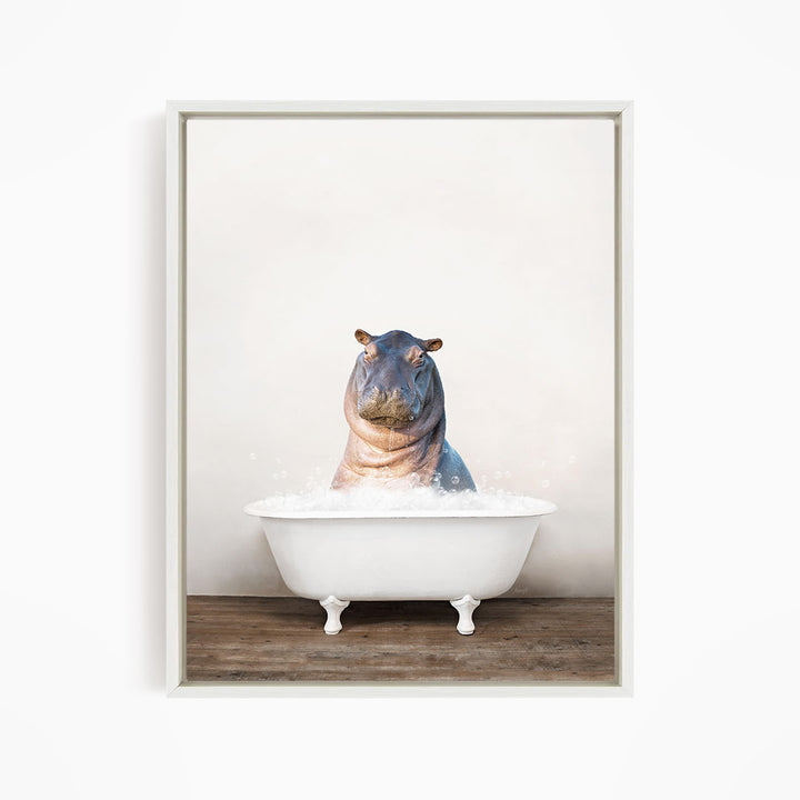 A hippopotamus sitting in a white bathtub filled with water, creating a whimsical and playful scene.