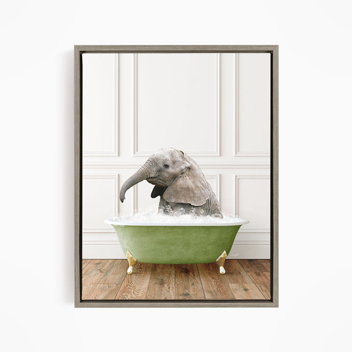 A baby elephant sitting in a green bathtub filled with water, appearing to enjoy the bath.