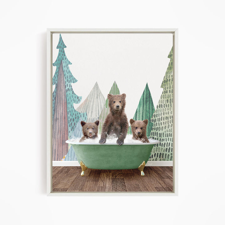 A framed print depicting three bears sitting in a green bathtub, with a forest scene in the background.