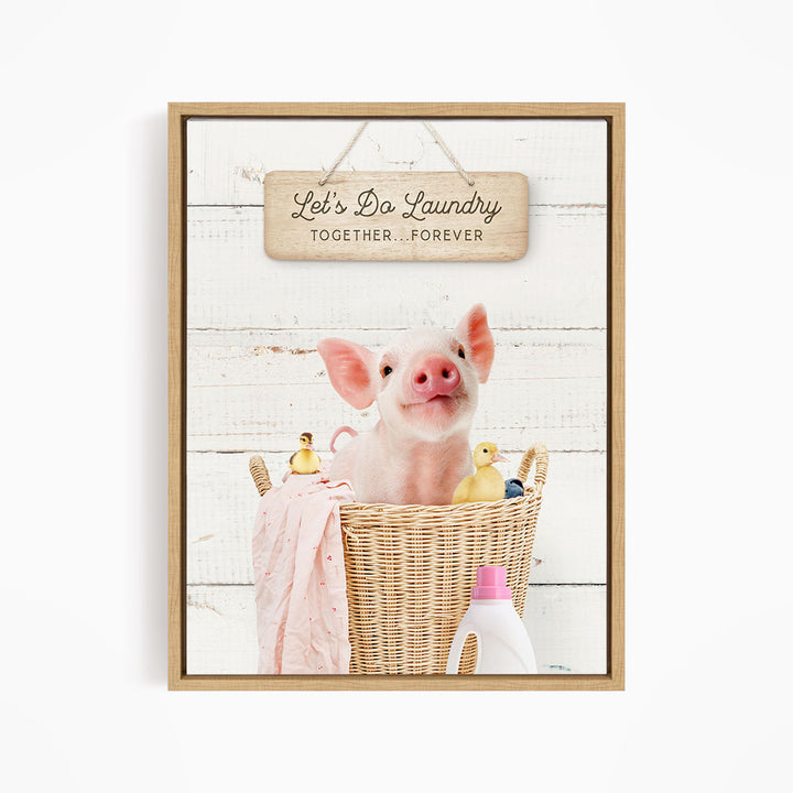 A cute pig sitting in a wicker basket filled with rubber ducks, accompanied by a wooden sign that says "Let's Do Laundry Together Forever".