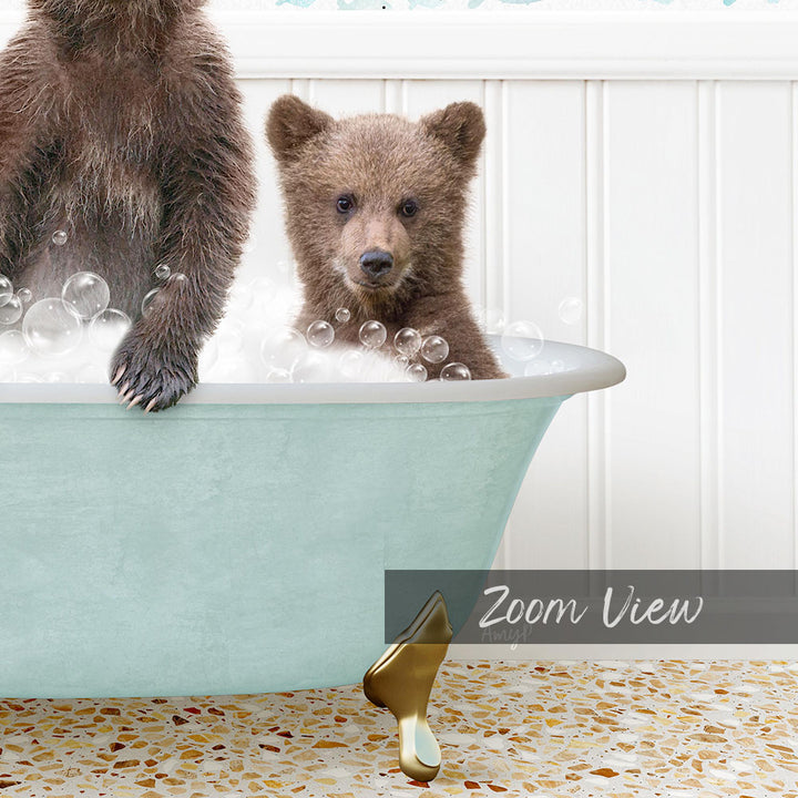 A baby bear sitting in a bathtub filled with bubbles, with a second bear standing next to it.