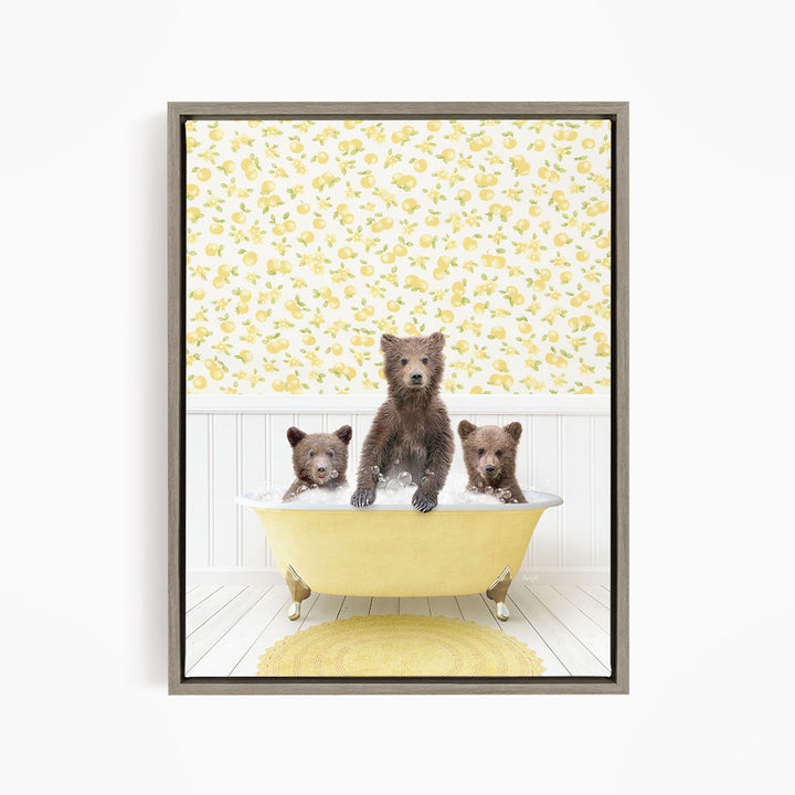A framed image depicting three bears sitting in a yellow bathtub, with a yellow floral wallpaper in the background.