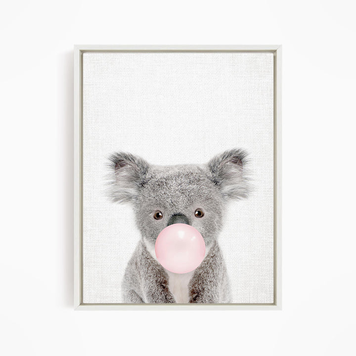 A cute koala bear blowing a bubble with a pink bubble gum bubble.