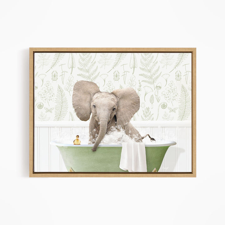A large elephant is sitting in a green bathtub filled with water, surrounded by a white wall with a pattern of leaves and ferns.