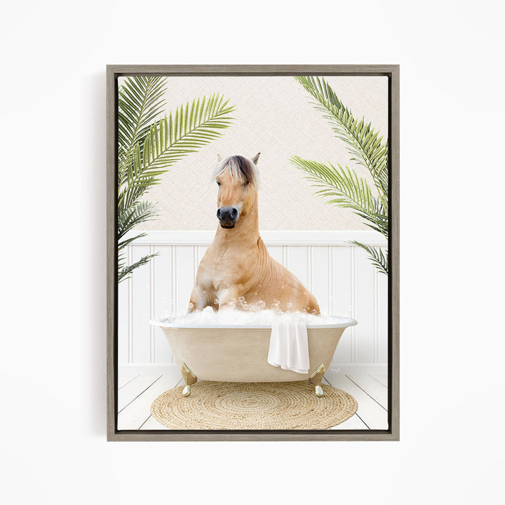 A light brown horse is sitting in a white bathtub filled with bubbles, surrounded by green palm leaves.