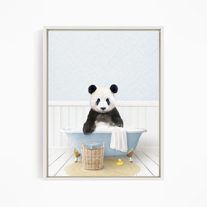 A panda bear sitting in a bathtub filled with water, surrounded by a yellow rubber duck and a basket.