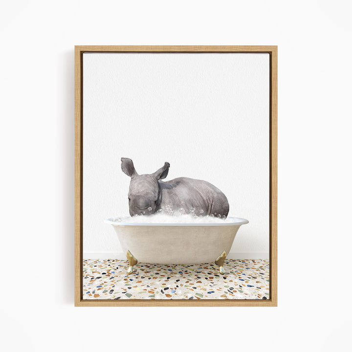 A rhinoceros is sitting in a bathtub filled with water, creating a whimsical and playful scene.