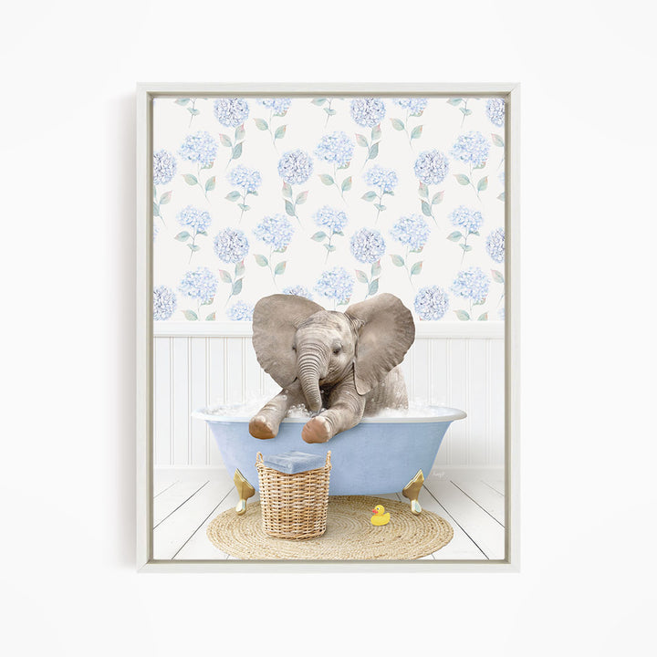 A baby elephant sitting in a blue bathtub, surrounded by a wicker basket and yellow rubber ducks.