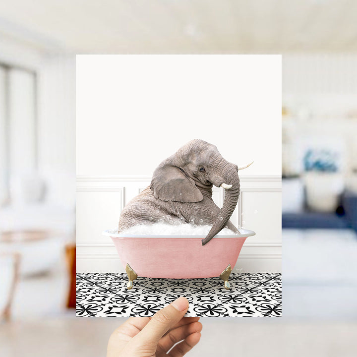 A gray elephant sitting in a pink bathtub filled with bubbles, surrounded by a black and white patterned floor.