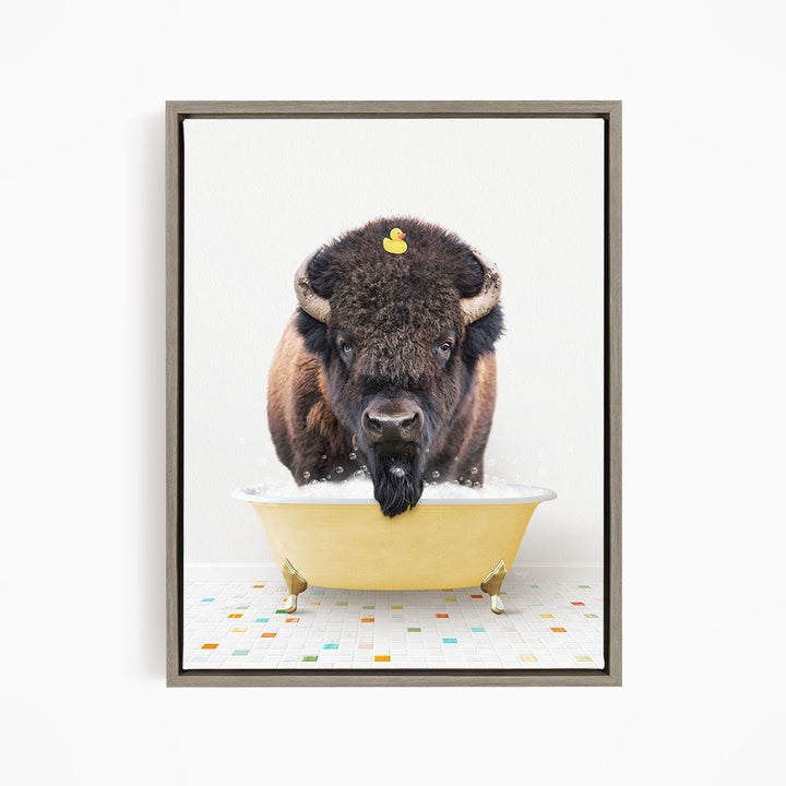 A buffalo with a yellow rubber duck sitting in a yellow bathtub.