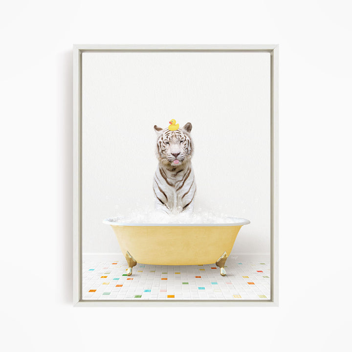 A white tiger is sitting in a yellow bathtub filled with bubbles, with a yellow rubber duck perched on its head.