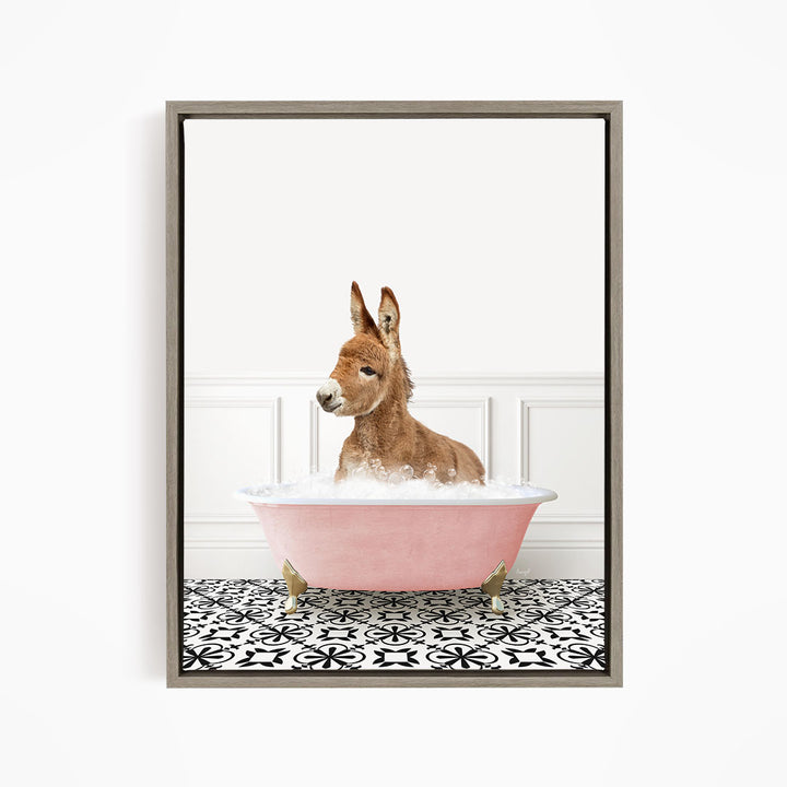 A donkey is sitting in a pink bathtub filled with bubbles, looking at the camera.