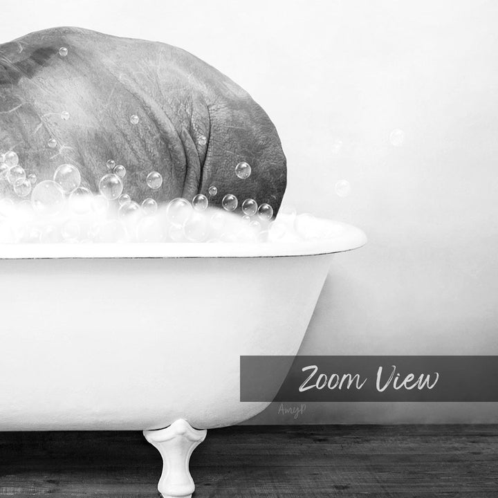 A black and white image showing a large elephant submerged in a bathtub filled with bubbles.