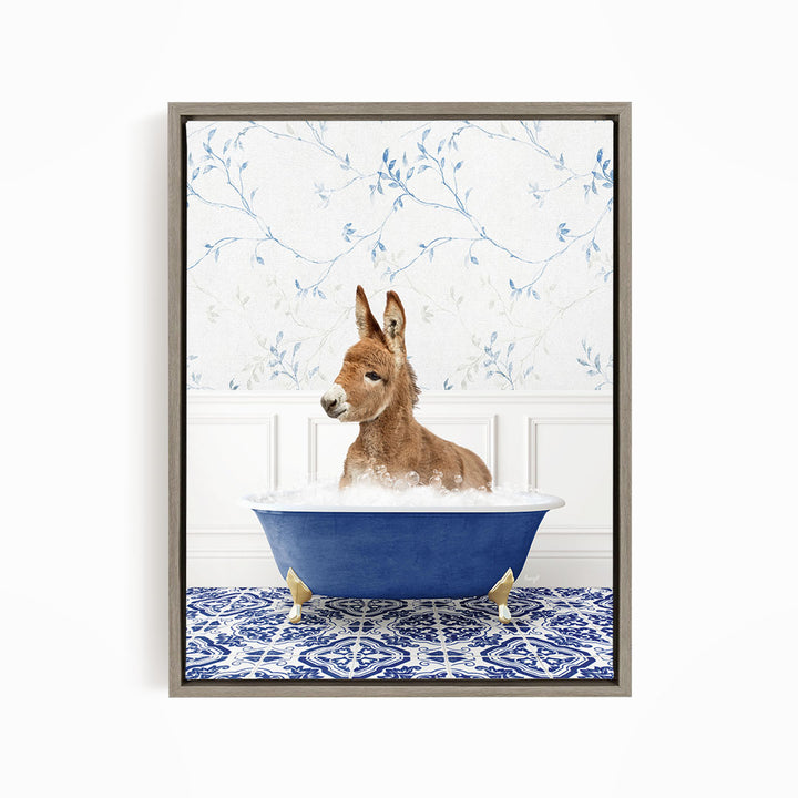 A donkey is sitting in a blue bathtub filled with bubbles, surrounded by a blue and white patterned rug and a floral wallpaper.