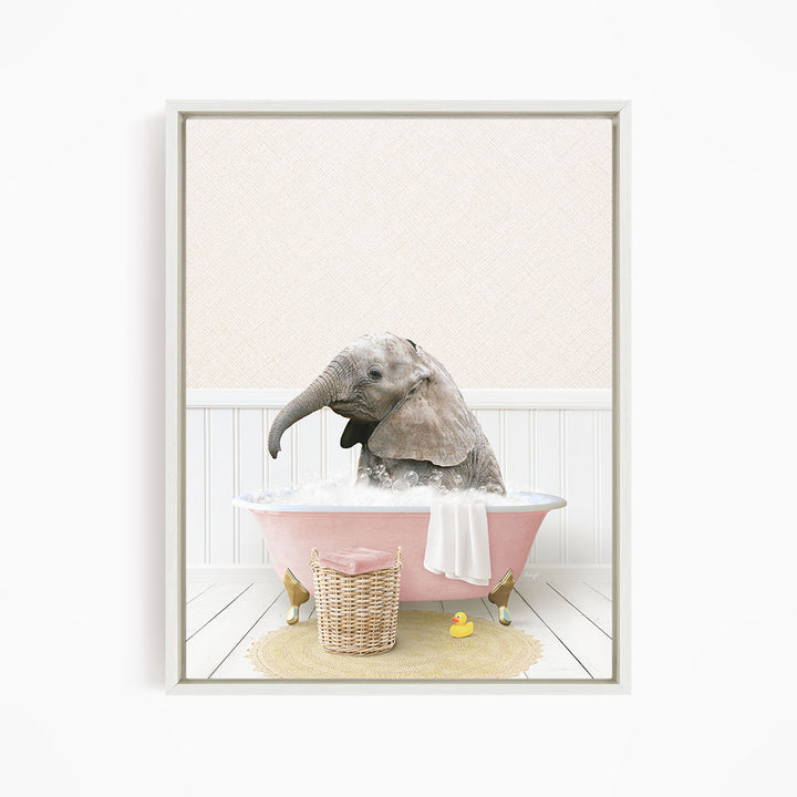 A baby elephant sitting in a pink bathtub filled with water, surrounded by a yellow rubber duck and a wicker basket.