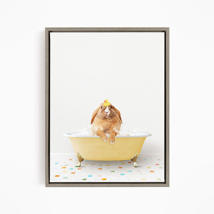 A brown rabbit sitting in a yellow bathtub filled with bubbles, wearing a yellow hat.