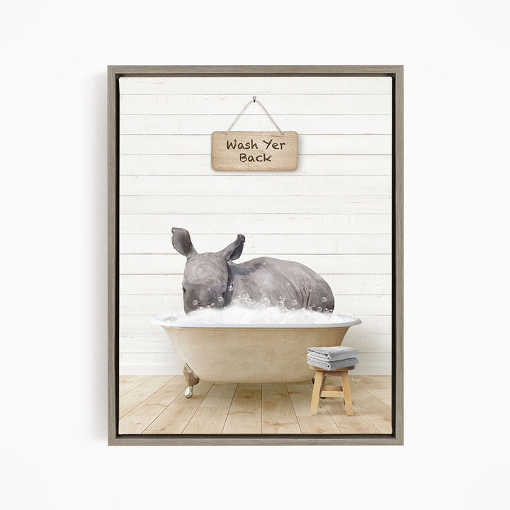 A rhinoceros is sitting in a bathtub filled with water, with a wooden sign above it that says "Wash Yer Back".