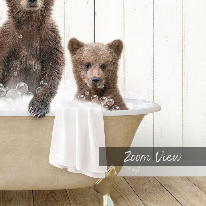 A young bear cub sitting in a bathtub filled with bubbles, with another bear cub sitting next to it.