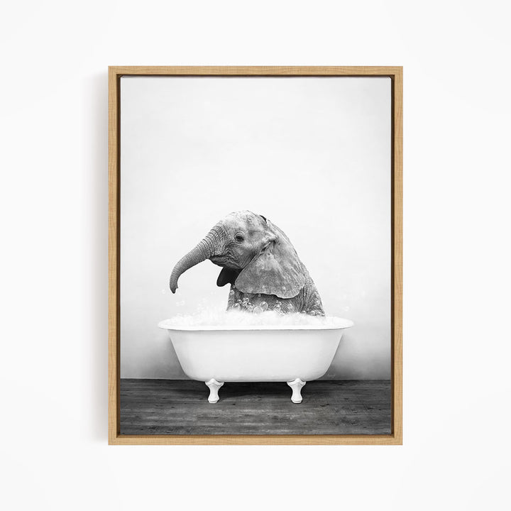 A baby elephant sitting in a bathtub filled with water, appearing to enjoy the bath.