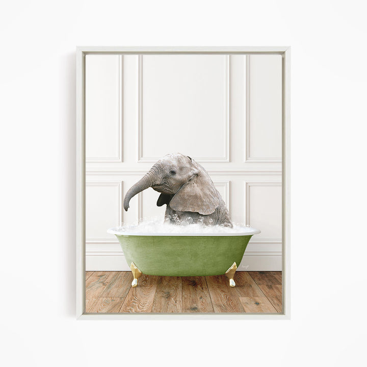 A baby elephant sitting in a green bathtub filled with water, appearing to enjoy the bath.