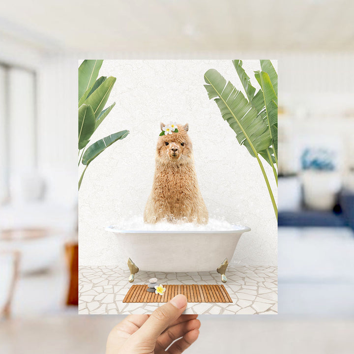 A hand is holding up a framed image of a fluffy brown dog sitting in a bathtub filled with bubbles, surrounded by tropical plants.