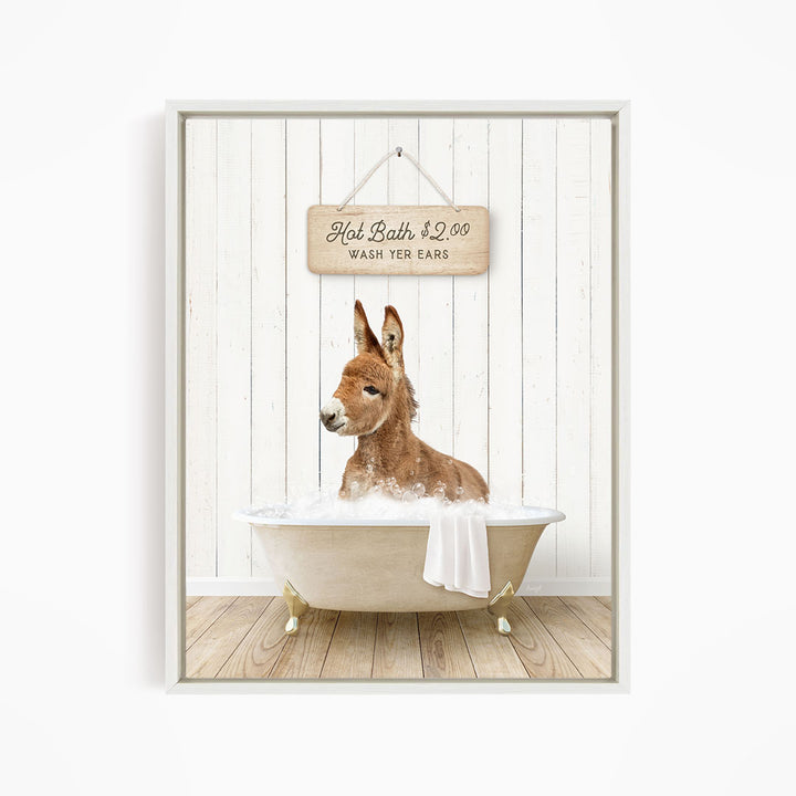 A donkey is sitting in a bathtub filled with water, with a sign above it that reads "Hot Bath $2.00 WASH YOUR EARS".