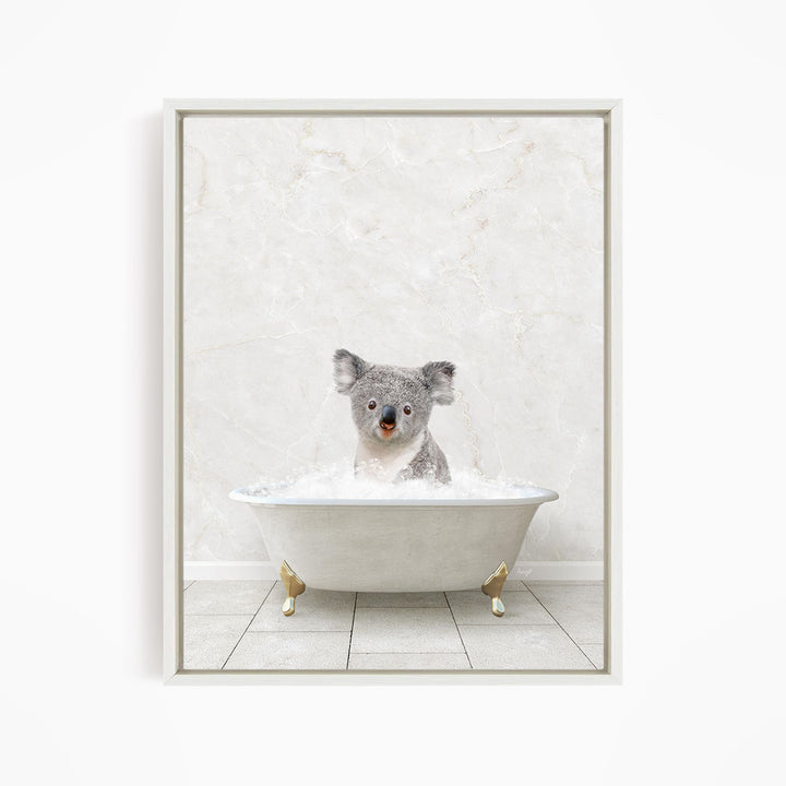 A koala bear sitting in a white bathtub filled with water, looking directly at the camera.