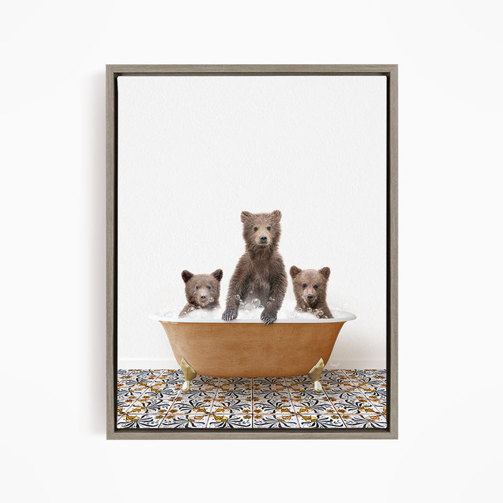 A framed image depicting three brown bears sitting in a bathtub filled with water, with a patterned tile floor beneath them.