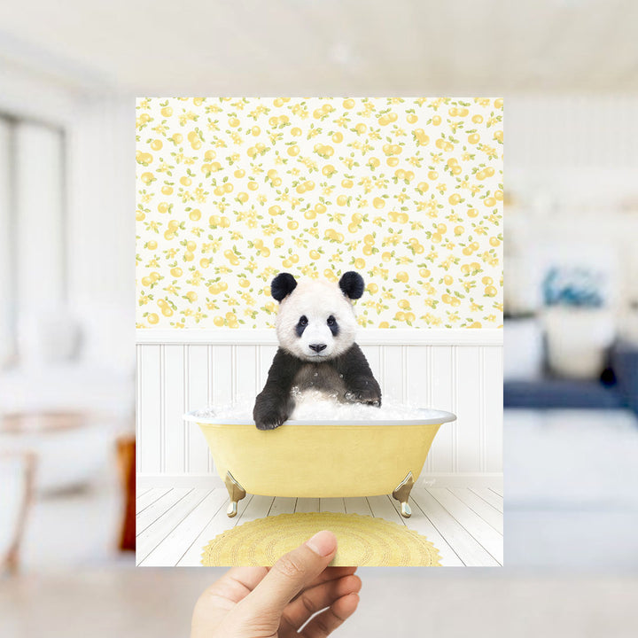 A panda bear sitting in a yellow bathtub filled with bubbles, surrounded by a yellow and white floral pattern on the wall.