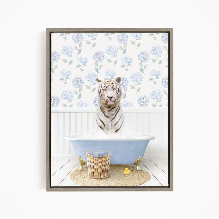 A white tiger is sitting in a blue bathtub filled with water, surrounded by a wicker basket and rubber ducks.