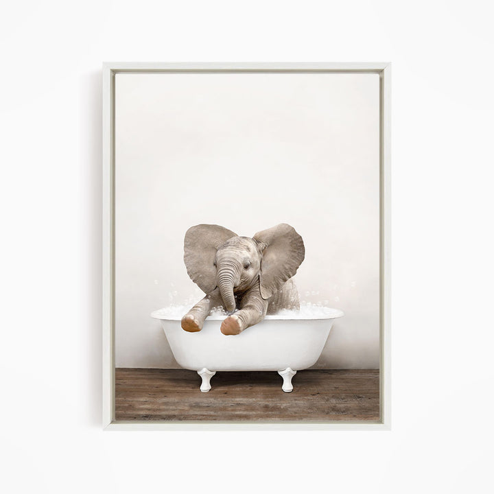 A baby elephant sitting in a white bathtub filled with water, with its trunk submerged in the water.