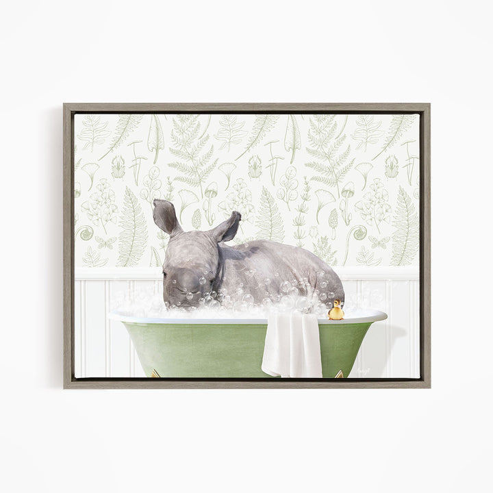 A rhinoceros is sitting in a green bathtub filled with water, surrounded by a white and green floral patterned wall.
