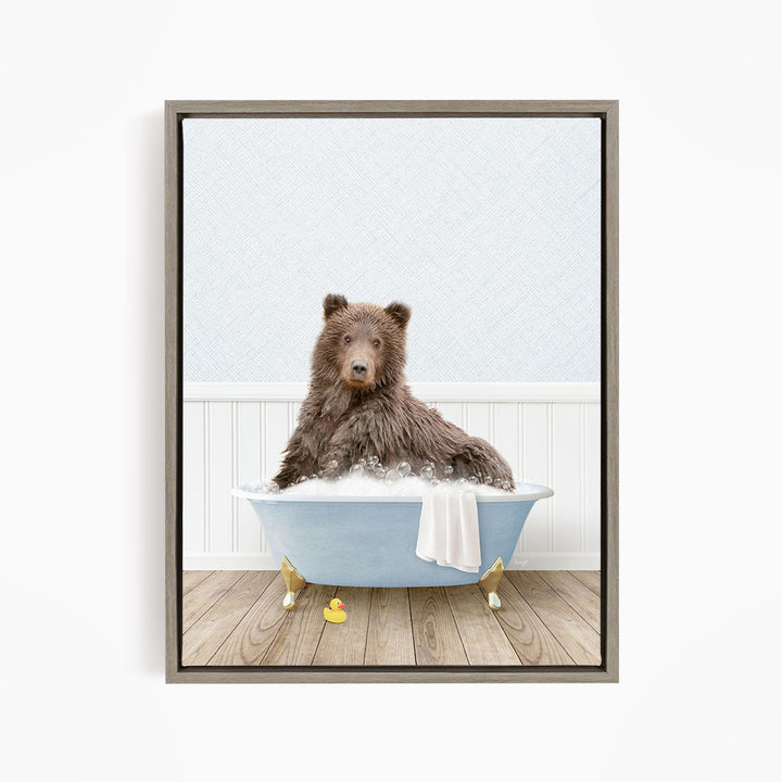 A brown bear sitting in a blue bathtub filled with bubbles, surrounded by rubber ducks.