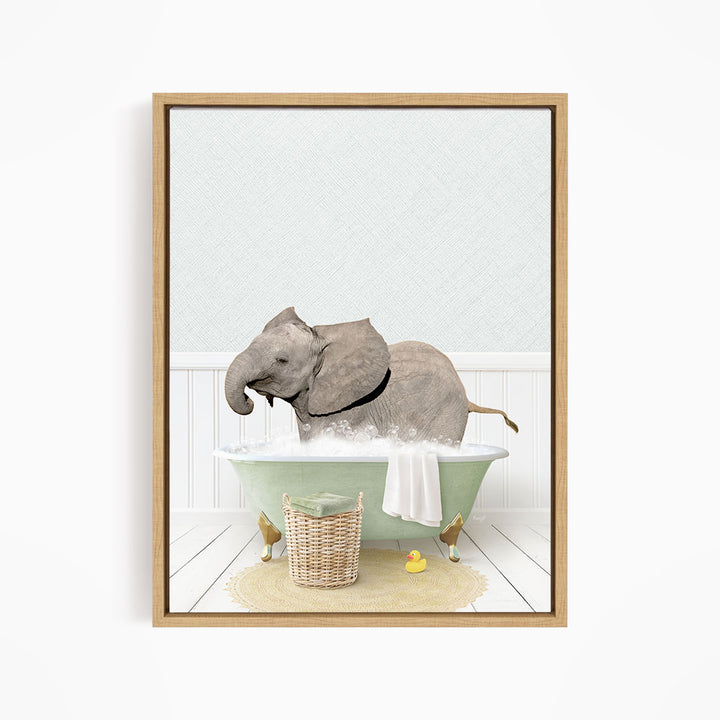 A gray elephant is sitting in a green bathtub filled with water, surrounded by a basket of toys and a yellow rubber ducky.